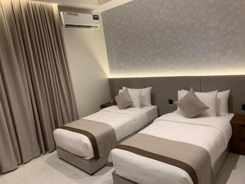 En eller flere senge i et værelse på البرج للشقق المخدومة 2