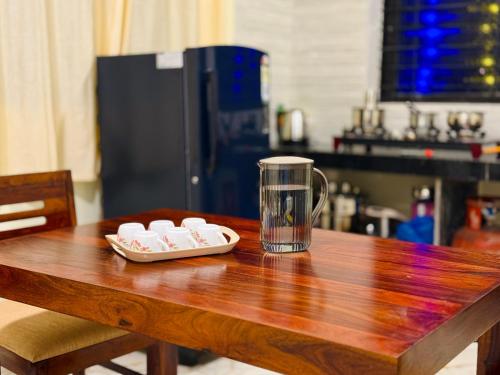 a wooden table with a coffee mug on top of it at Sadanand Villa in Jāmb