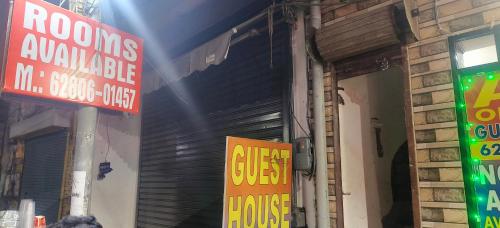 a store with signs on the side of a building at A One Guest House in Jalandhar