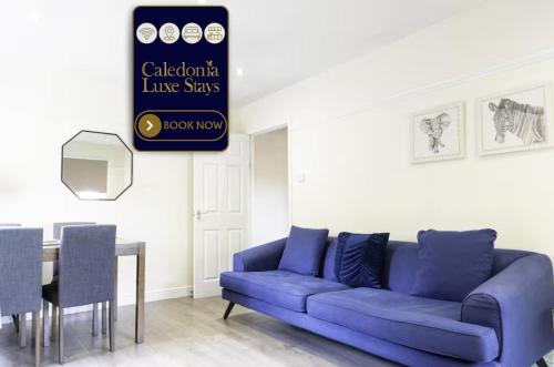 a living room with a blue couch and a table at The Riverside in Alloa
