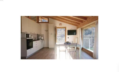 Una cocina con una mesa y un comedor. en Rustico Prato Grande con vista lago, en Carriola