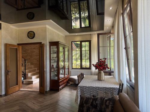 a large room with a table and some windows at Villa Kolkhi in Kvariati