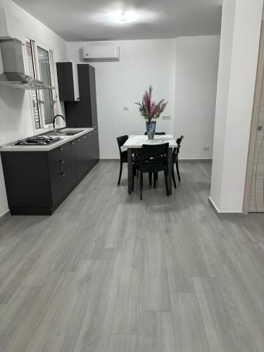 a kitchen and dining room with a table and chairs at BALISTRERI HOUSe in Trabia