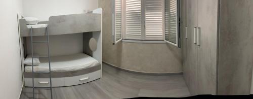 a small room with a bunk bed and a window at BALISTRERI HOUSe in Trabia