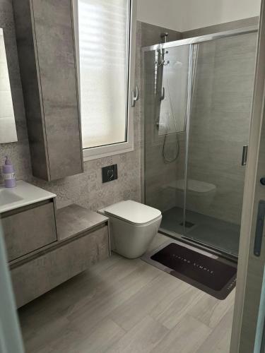 a bathroom with a shower and a toilet and a sink at BALISTRERI HOUSe in Trabia