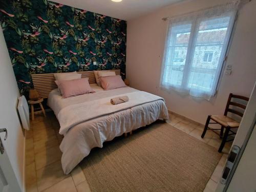 Ένα ή περισσότερα κρεβάτια σε δωμάτιο στο Les Iles d'ici