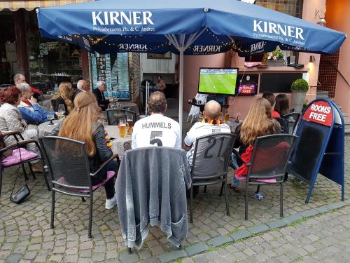 a group of people sitting at a table in a restaurant at Hotel-Café-Burg Stahleck in Bacharach