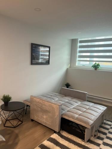 a bedroom with a large bed and a window at Livingston Calgary Lovely space in YYC