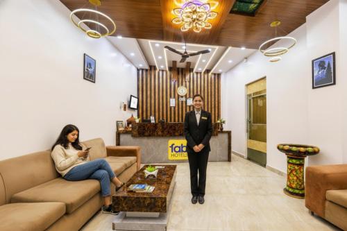 un hombre y una mujer de pie en una sala de estar en FabHotel Airport Sinon, en Nueva Delhi