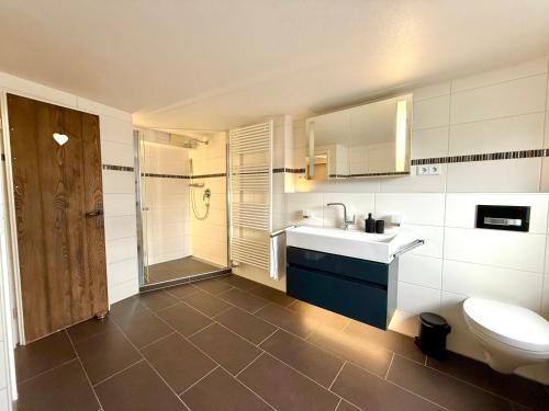 a bathroom with a toilet and a sink and a shower at Ferienhaus Alpenlodge in Oberstdorf