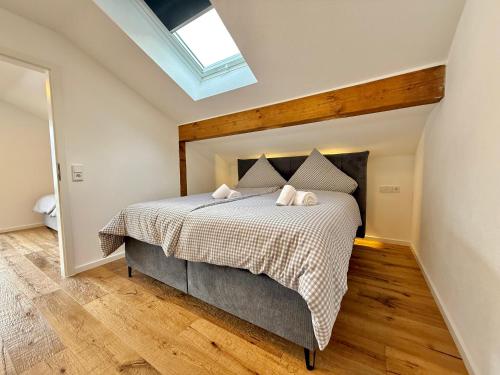 a bedroom with a bed and a skylight at Ferienhaus Alpenlodge in Oberstdorf