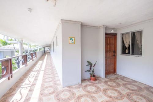 an empty hallway with a door and a potted plant at Casa del Sol - Poolside Villa in Quepos