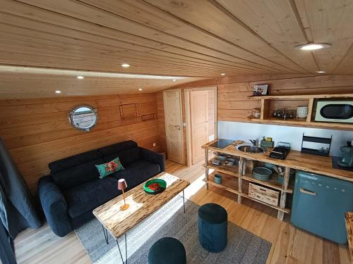 a living room with a couch and a table at La toue Belle de Maine - Bateau traditionnel de la Loire in Angers