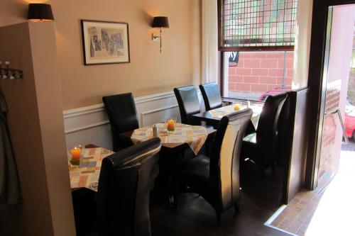 a dining room with two tables and black chairs at Hotel-Café-Burg Stahleck in Bacharach