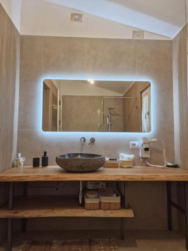 a bathroom with a sink and a large mirror at Bed & Breakfast Oasi San Giovanni in Altamura