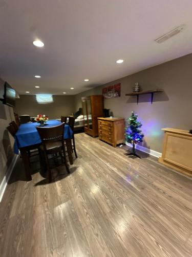 a living room with a table and a christmas tree at Cozy 2 Beds Basement Suite in Windsor