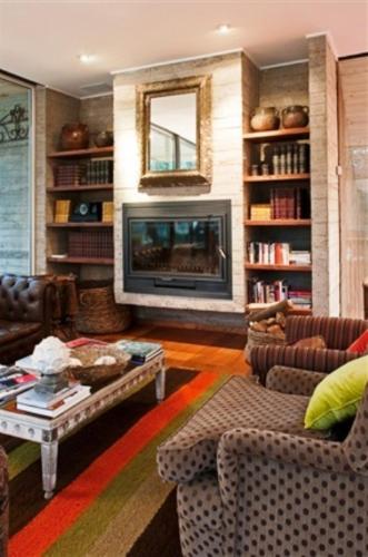 a living room filled with furniture and a fireplace at Hotel Casa Zapallar in Zapallar