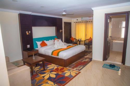 a hotel room with a bed and a bathroom at Gautam Buddha International Hotel Ltd in Gautam Buddha International Airport