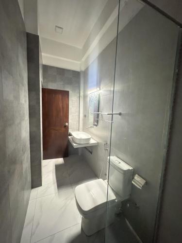 a bathroom with a toilet and a sink at The Reef Resort in Nilaveli