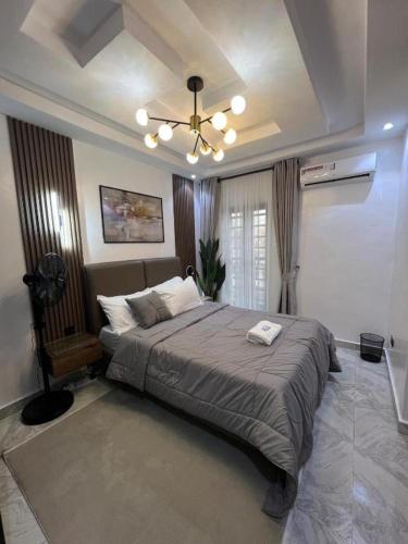 a bedroom with a large bed and a ceiling at Hertz Studio in Lagos