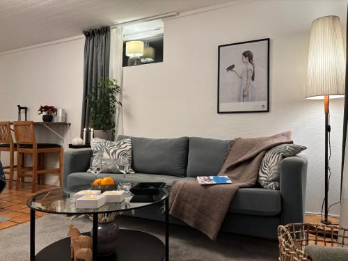 a living room with a couch and a table at Sundsvall By M - Basement Studio in Sundsvall