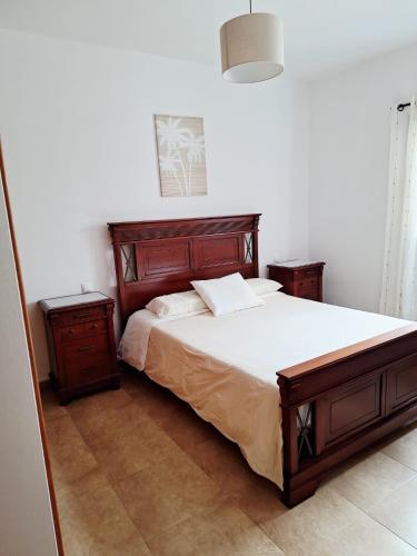 a bedroom with a large bed and two night stands at La Caracola in La Santa