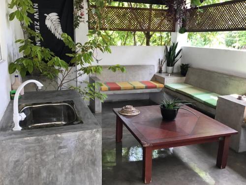 a living room with benches and a table at Everdew Kandy Rooms in Kandy