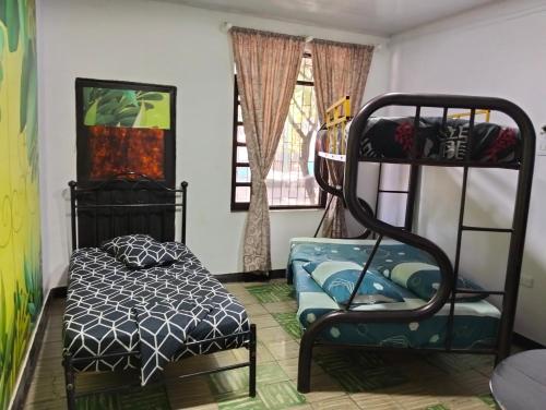 a bedroom with a bunk bed and a chair at hostal el gato in Utica