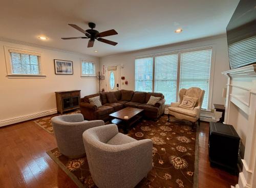 a living room with a couch and chairs and a ceiling fan at Modern Cottage Downtown NPT-Waites Wharf Cottage RE05618-STR in Newport
