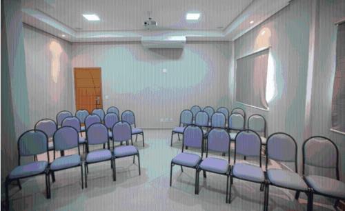 a room with a bunch of blue chairs in it at Skala Traveling Hotel in Cuiabá