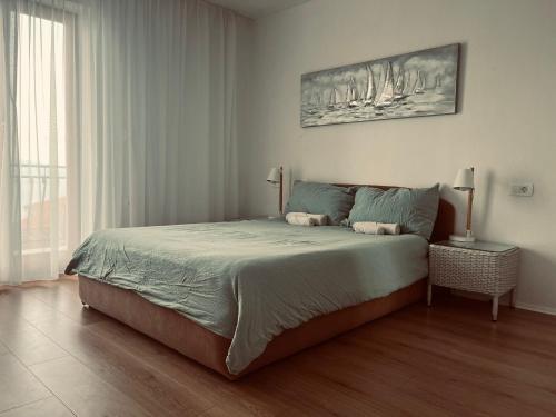 a bedroom with a bed and a large window at Island view 1 in Novi Vinodolski