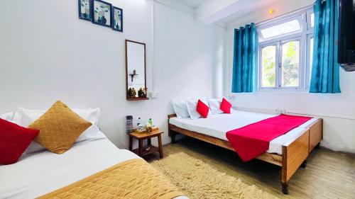 a bedroom with two beds and a window at Jo'stel Hotel Winter Green- MG Marg in Gangtok