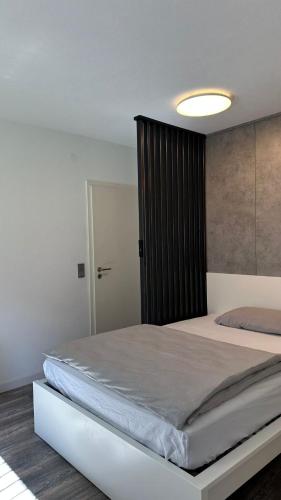 una camera da letto con un letto grande con testiera nera di Casa Verona a Landstuhl