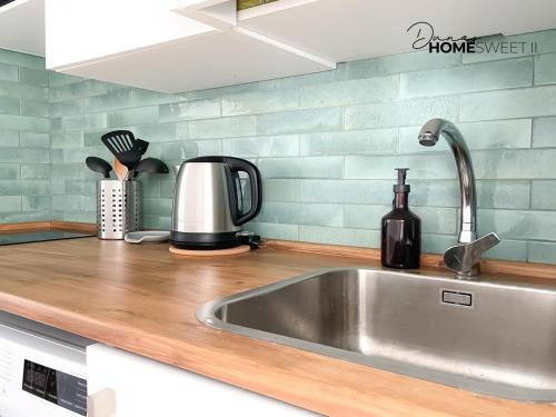 a kitchen counter top with a sink and a counter top at Oasis Dunas Sweet Family Home II Pool view by B-Rent in Corralejo