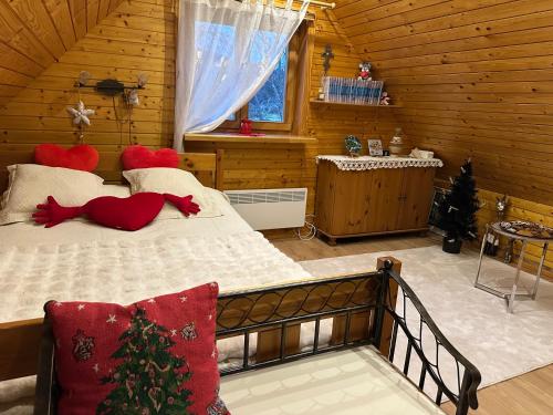 a bedroom with a bed in a log cabin at Norieši in Vangaži
