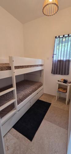 a bedroom with two bunk beds and a chandelier at Jolie maison neuve entre mer et colline en Provence in Ollioules
