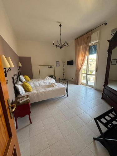 a bedroom with a bed and a chandelier at LillaBloom in Nocera Inferiore
