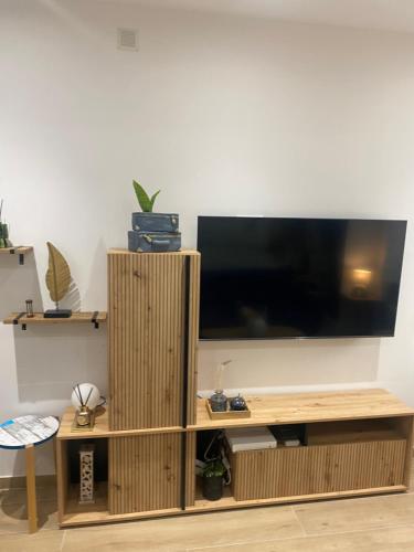 a living room with a large flat screen tv at L'horizon De Coursan in Coursan