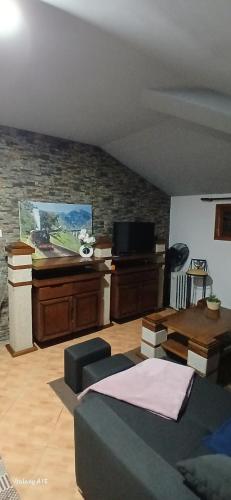 a living room with a couch and a table at Ferradosa GuestHouse in São João da Pesqueira