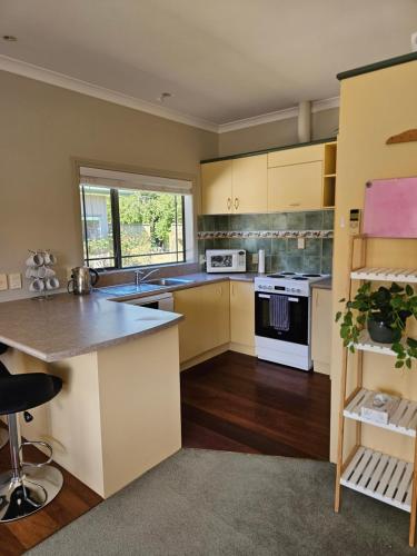 a kitchen with yellow cabinets and a counter top at Ridgetop cottage in Wairakei