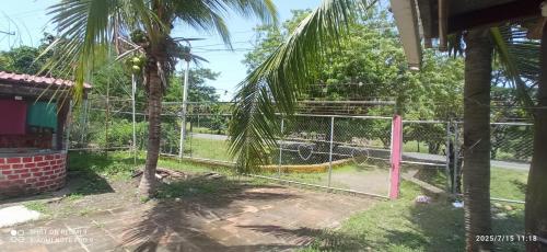 a batting cage in a park with a playground at hostal Casa pura vida in Rivas
