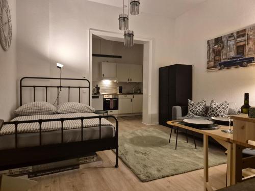 a bedroom with a bed and a living room at Appartment Rheinaue in Duisburg