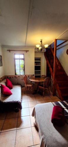 a living room with a couch and a table at Mountain Haven Kaapsehoop in Kaapsehoop