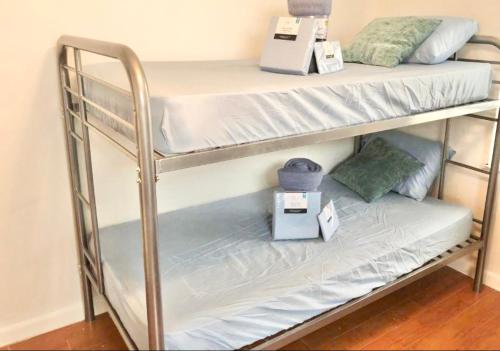 a couple of bunk beds in a room at Peace and Quiet Dorm Rooms - Free Breakfast DIY Waffles - Free Dinner - Free Coffee - Longterm Ok! in Miami
