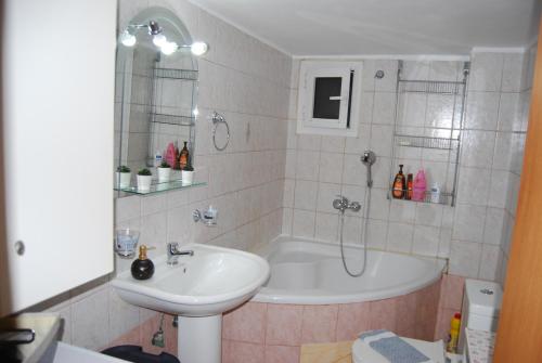 a bathroom with a sink and a bath tub at sofi in Komotini