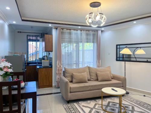 a living room with a couch and a table at Keisha Luxury Furnished Apartment Bukoto in Kampala