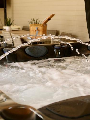 a sink with snow and ice on top of it at Lough View Cottage in Killinchy
