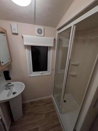 a bathroom with a shower and a sink at Stay static Hayling island holiday park in South Hayling