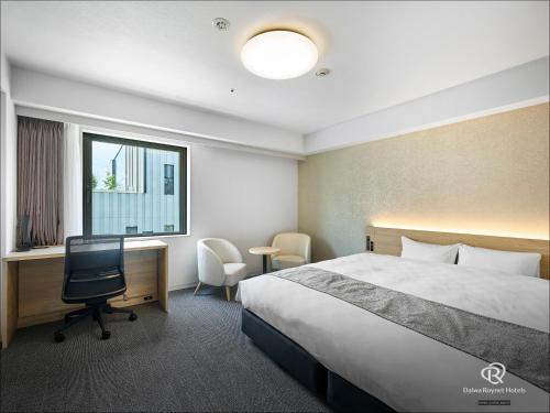 a hotel room with a bed and a desk and a computer at Daiwa Roynet Utsunomiya in Utsunomiya