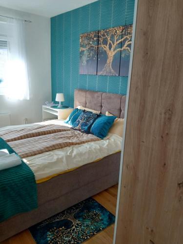 a bedroom with a large bed with blue walls at Natura Lux & Parking Free - Green Hill, blizu Akva parka in Soko Banja